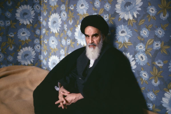 Ayatollah Ruhollah Khomeini seated looking at camera